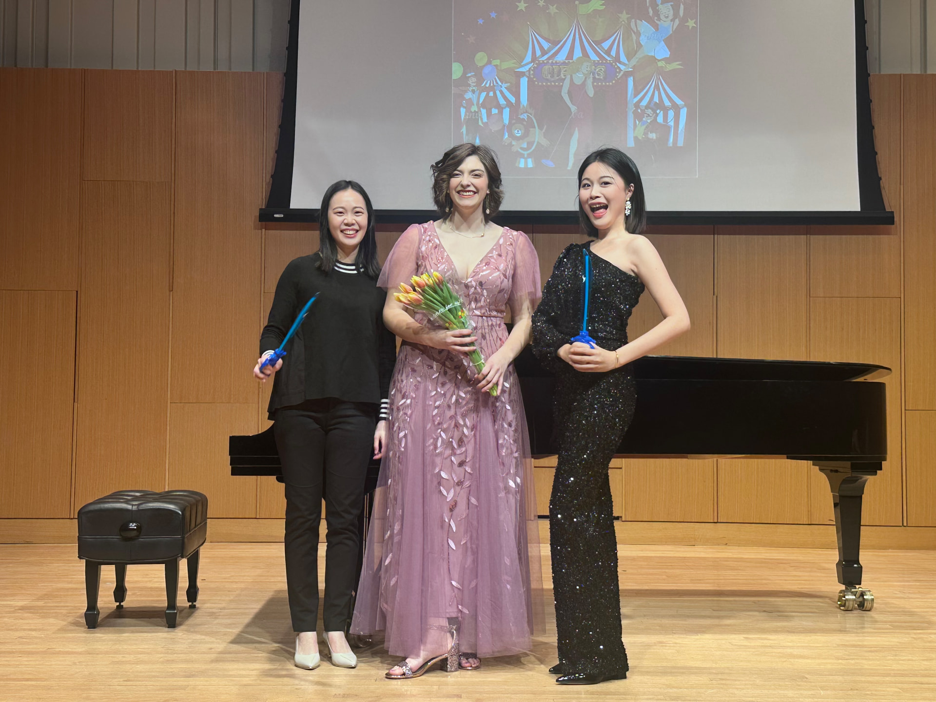 Yi-Hui Chen on stage with two singers after an opera scenes performance