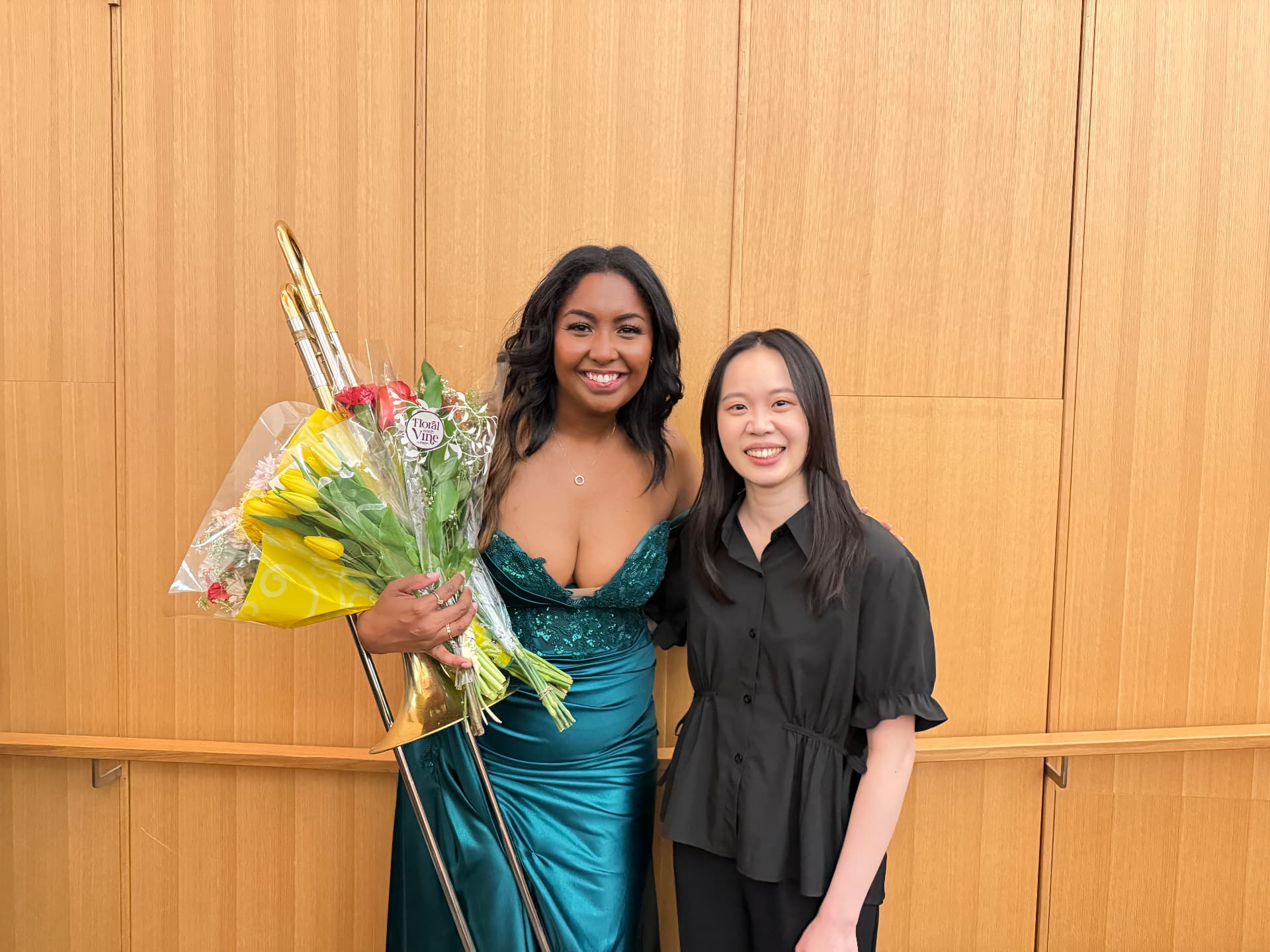 Yi-Hui Chen with a trombonist holding flowers after a recital