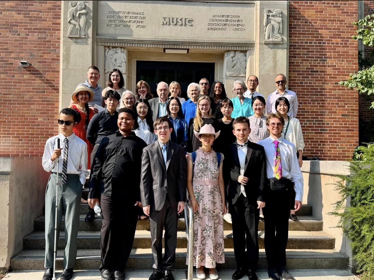 Yi-Hui Chen with participants and faculty on the steps of the Michigan State University Music building