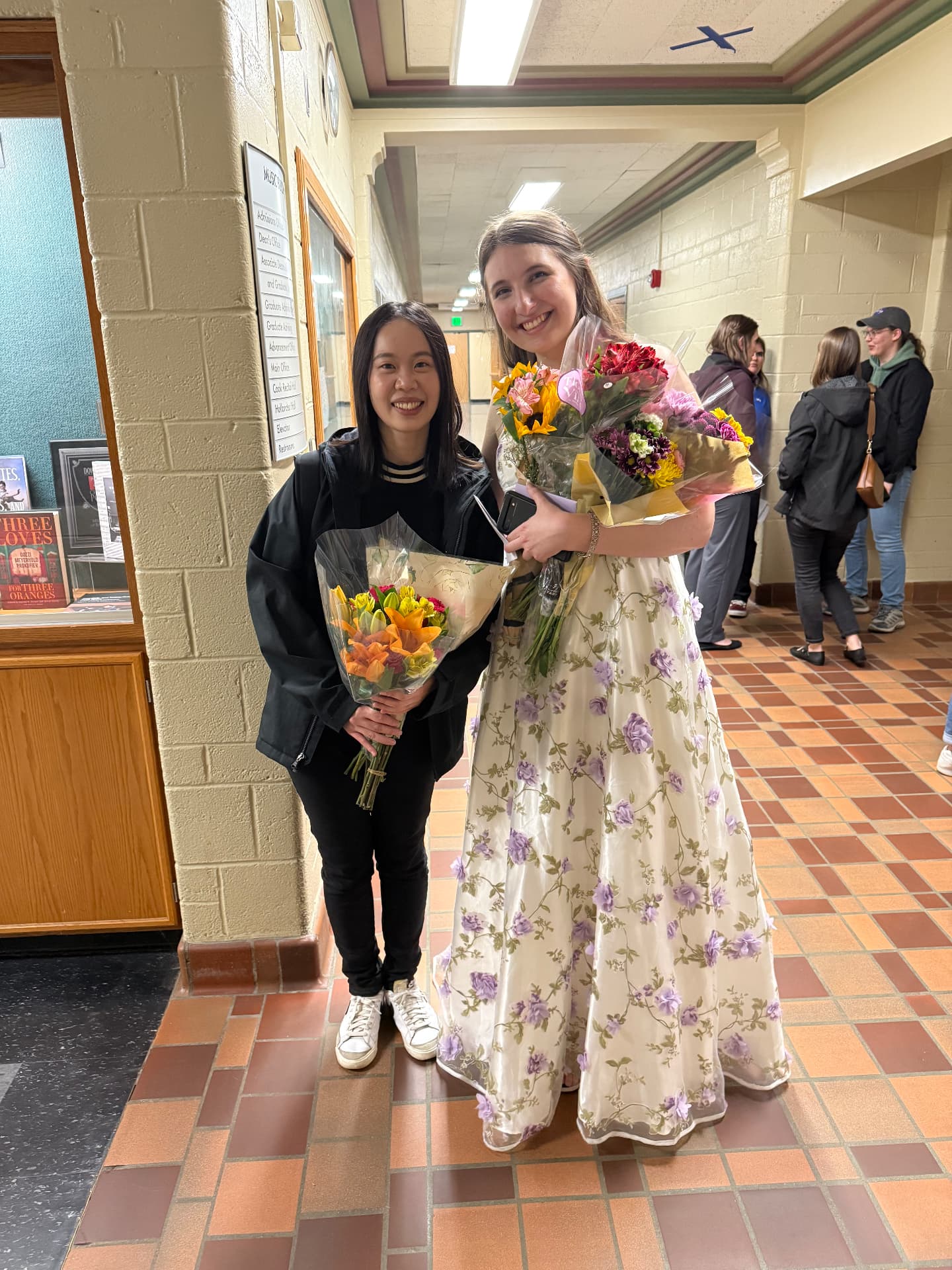 Yi-Hui Chen with a student holding flowers after a recital