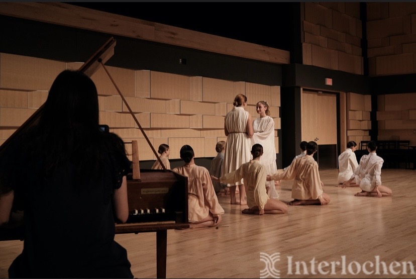 Yi-Hui Chen at the harpsichord accompanying ballet dancers in white costumes on the Interlochen stage