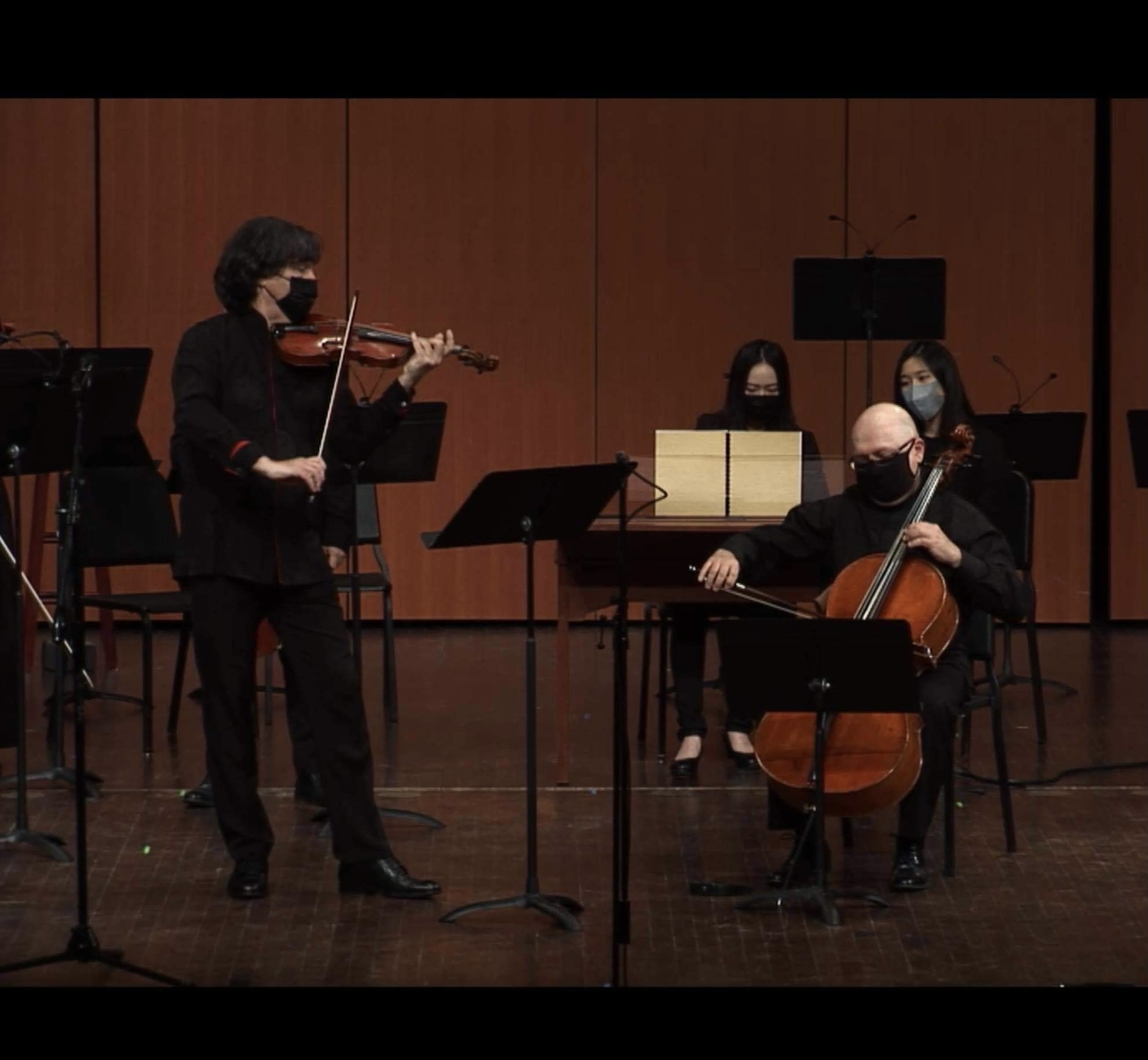 Yi-Hui Chen at the harpsichord performing with violin and cello on a wooden concert stage