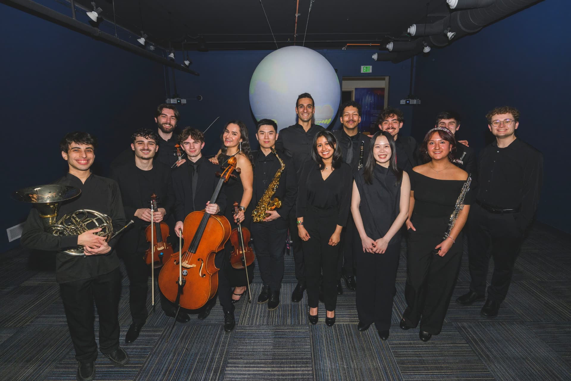 Yi-Hui Chen backstage with a group of fellow musicians holding their instruments