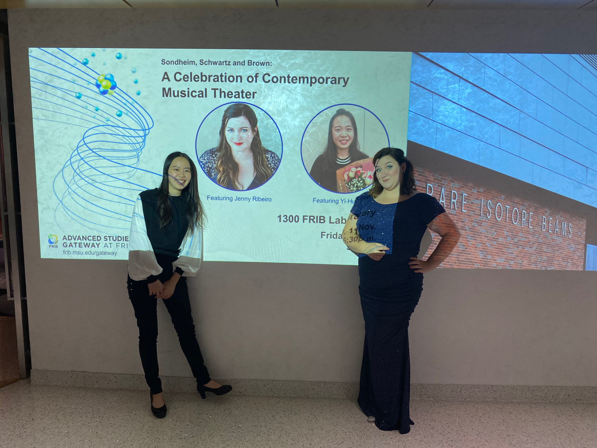 Yi-Hui Chen with soprano Jenny Ribeiro in front of the presentation screen for A Celebration of Contemporary Musical Theater at FRIB